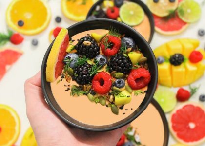 Colorful bowl of fresh fruits with a mix of berries and seeds, perfect for a healthy meal.